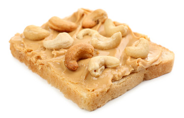 Bread slice with creamy peanut butter, isolated on white