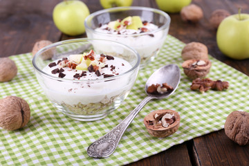 Oatmeal in bowls, yogurt, apples and walnuts