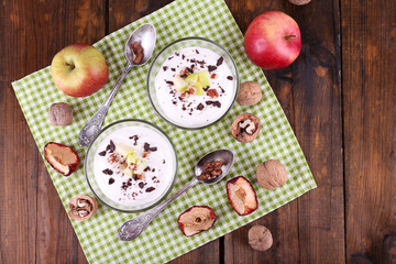 Oatmeal in bowls, yogurt, apples and walnuts