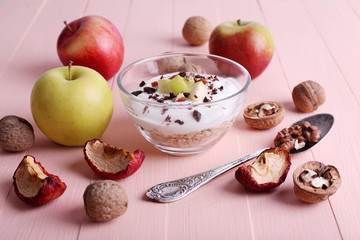 Oatmeal with yogurt in bowls/bowl, apples and walnuts
