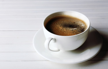 Cup of coffee on wooden table