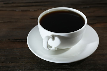 Cup of coffee on wooden table