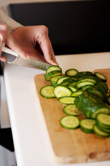 Woman slicing cucumber