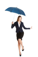 Businesswoman dancing with umbrella