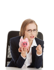 Businesswoman holding a piggybank