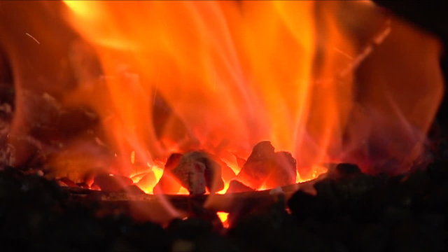 Forging a fire for heating metal, slow motion 1