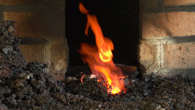 Forging a fire for heating metal, slow motion