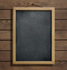 Fototapeta na wymiar chalkboard or blackboard hanging on wooden wall