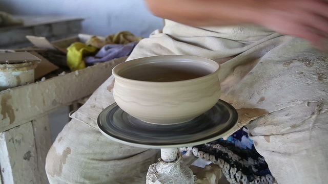 potter sculpts clay small pot