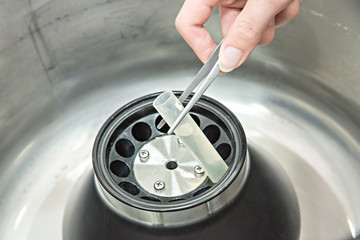 Scientist loading a sample to centrifuge