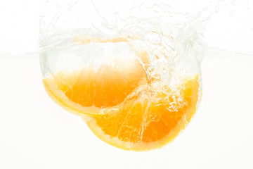 Orange Slices falling deeply under water with a big splash