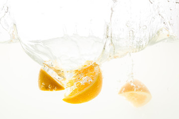 Orange Slices falling deeply under water with a big splash