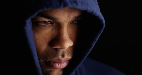 African man wearing blue sweater