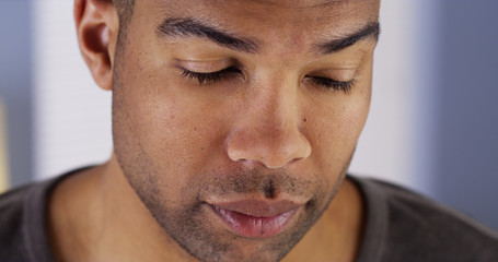 Black man with eyes closed