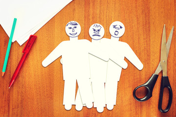 Three paper male characters with different emotions