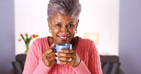 Mature black woman smiling with coffee mug