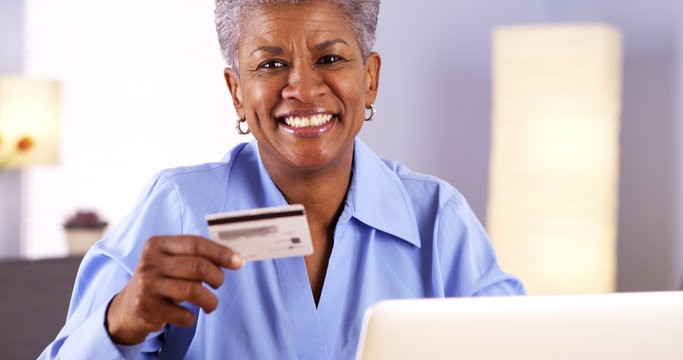 Happy Mature Black Woman Typing In Card Information