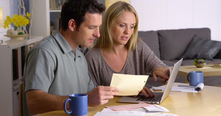 Couple doing their finances with laptop