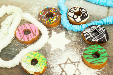 bright donuts on wooden background