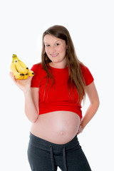 young pregnant woman with bananas