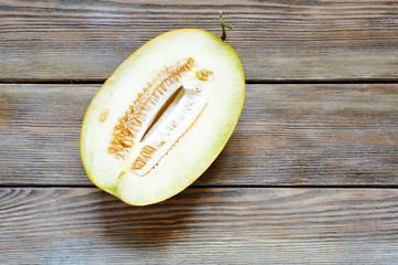 half ripe melon on wooden background