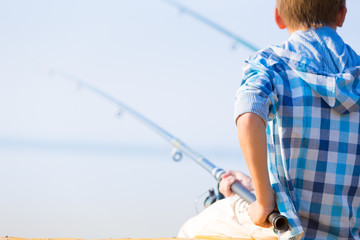 Close-up of hands of a boy with a fishing rod