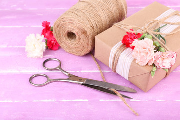 Beautiful gift with flowers and decorative rope,