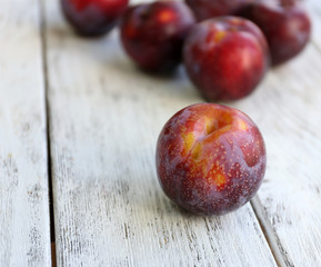Sweet plums on wooden background