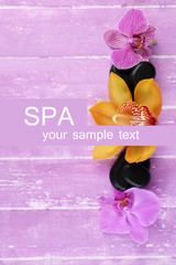 Composition with beautiful blooming orchids and spa stones