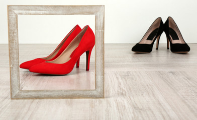 Black and red women shoes with frame on floor