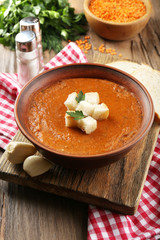 Delicious lentil cream-soup on table close-up