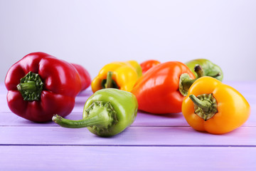 Pepper on wooden table on light background