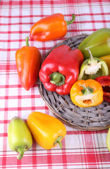 Pepper on wicker mat on fabric background