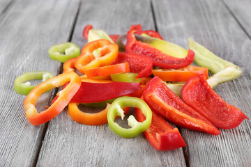 Sliced pepper on wooden background