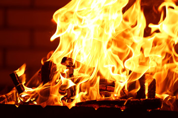 Bonfire at night on brick wall background