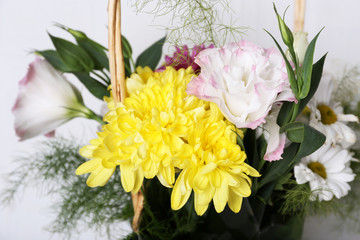 Flowers in basket on white background