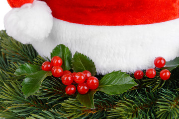 Obraz na płótnie Canvas Leaves of mistletoe with Christmas hat close-up