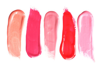 Different lip glosses isolated on white