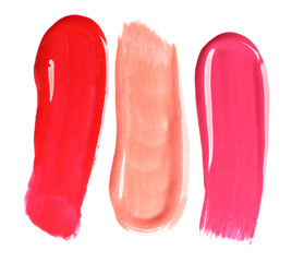 Different lip glosses isolated on white