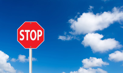 roadside red stop sign on a cloudy background.
