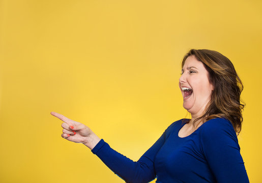 happy laughing woman pointing finger at something