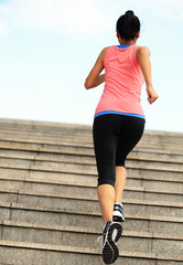  Runner athlete running on stairs. woman fitness jogging workout