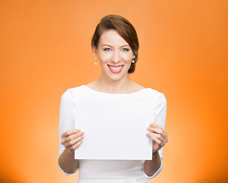 Woman holding blank paper sheet banner isolated on orange