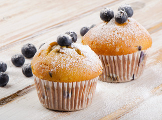 Blueberries muffins   on a  wooden background