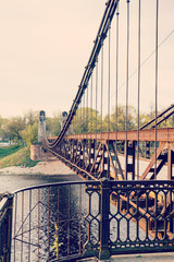 old rusty steel suspension bridge