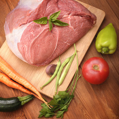  raw meat and vegetables on a cutting board