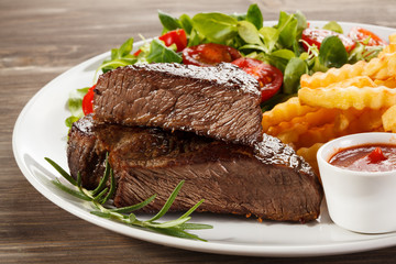 Grilled steak, French fries and vegetables