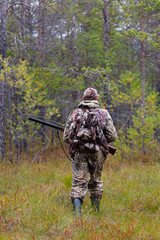 hunter shooting on the forest edge