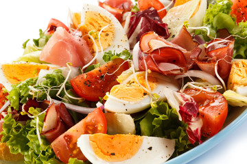 Boiled eggs with smoked ham and vegetables