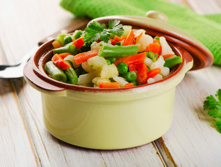 Mixed vegetables in a bowl on  wooden table